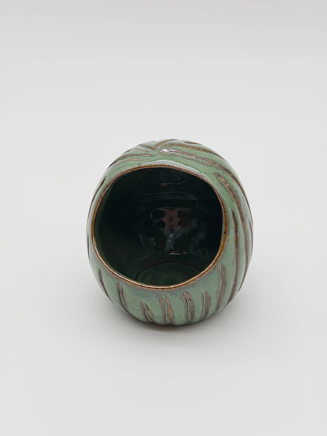 Green glazed salt dish with a rounded opening and carved lines, view 2