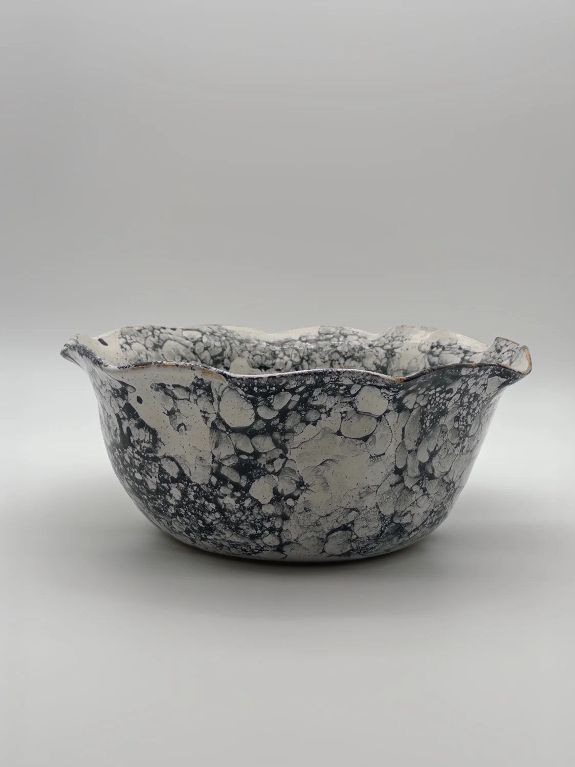 Large white bowl with a black bubble pattern and a wavy rim, view 2