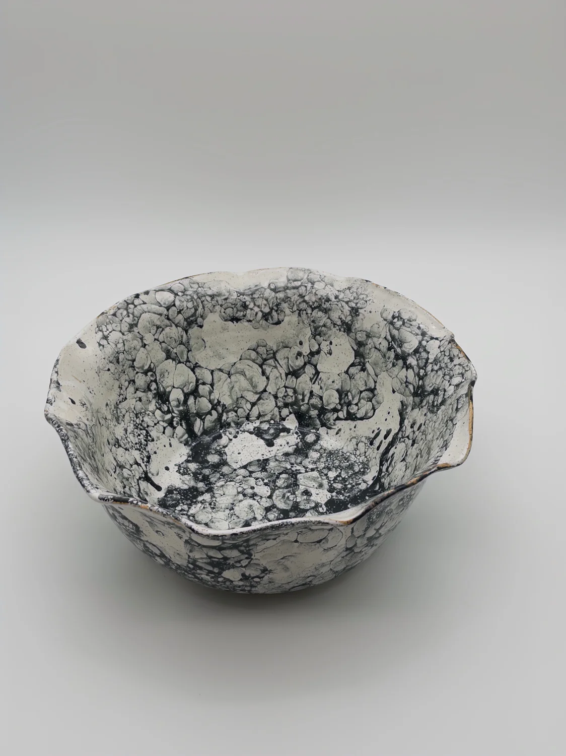 Large white bowl with a black bubble pattern and a wavy rim, view 3