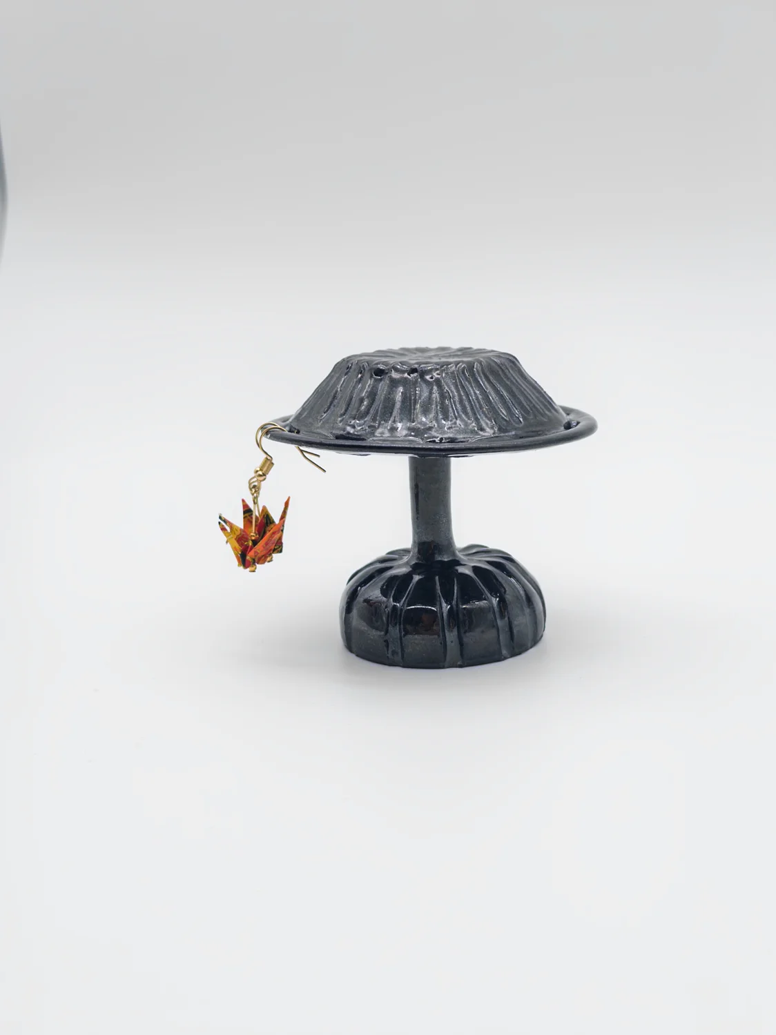 Dark glazed mushroom-shaped earring holder
