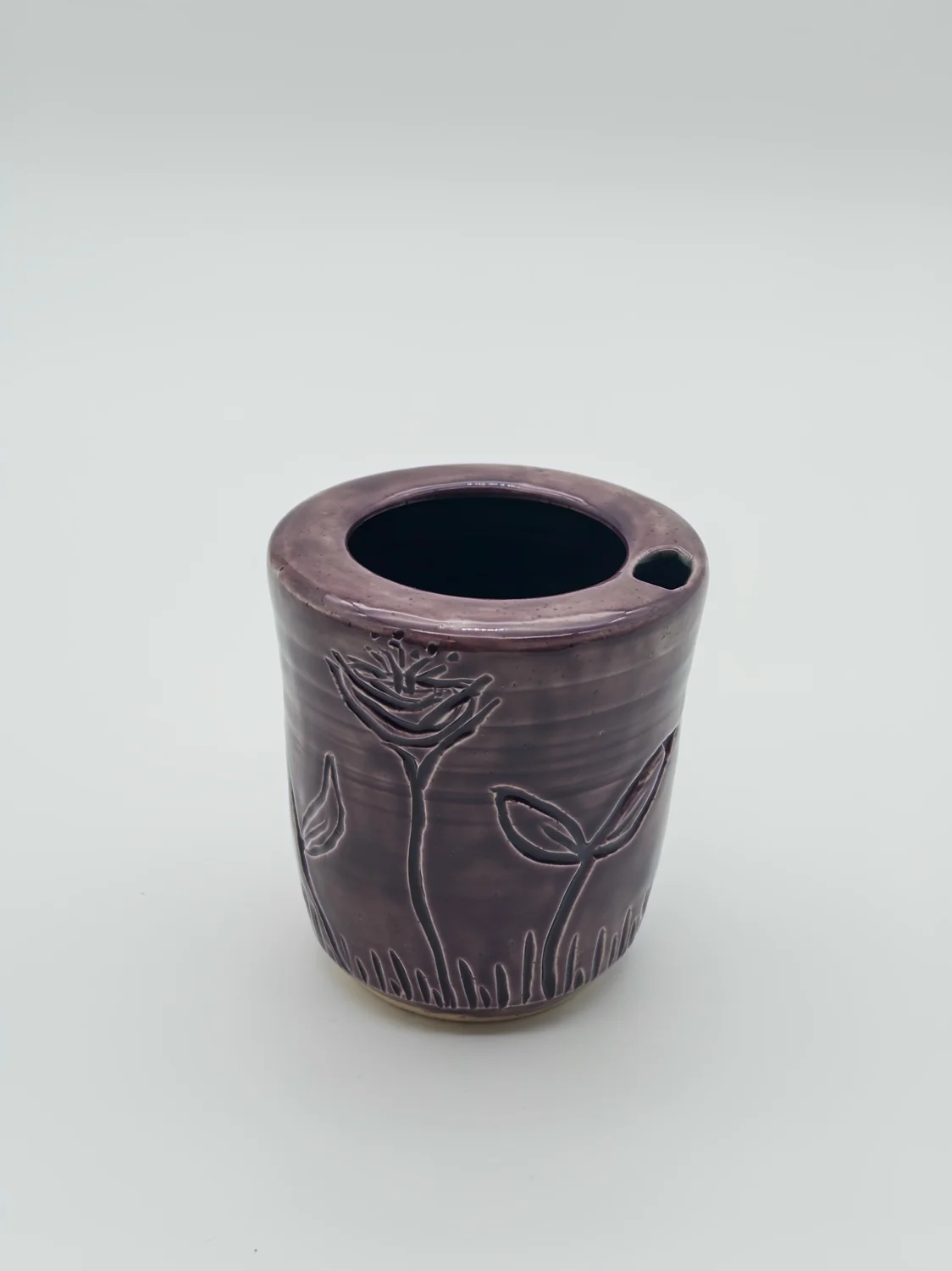 Purple travel cup with carved flowers and a sipping opening, view 3